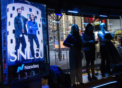 People watch current and veteran members of the SNL cast celebrate SNL as they ring the Nasdaq opening bell, in New York's Times Square, Thursday, Feb. 14, 2025. (AP Photo/Eduardo Munoz Alvarez)