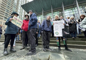 People gather outside the U.S. District Court after a federal judge blocked President Donald Trump's effort to halt the nation's refugee admissions system Tuesday, Feb. 25, 2025, in Seattle. (AP Photo/Eugene Johnson)