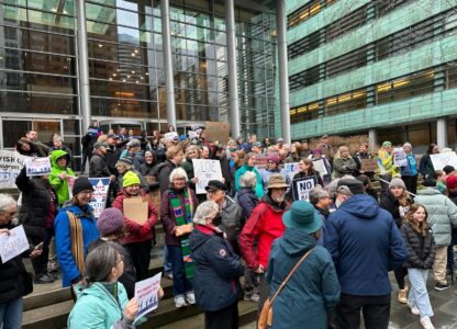 People gather outside the U.S. District Court after a federal judge blocked President Donald Trump's effort to halt the nation's refugee admissions system Tuesday, Feb. 25, 2025, in Seattle. (AP Photo/Eugene Johnson)