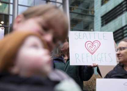 People gather outside the U.S. District Court after a federal judge blocked President Donald Trump's effort to halt the nation's refugee admissions system Tuesday, Feb. 25, 2025, in Seattle. (AP Photo/Ryan Sun)