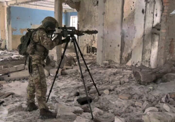 In this photo taken from video distributed by Russian Defense Ministry Press Service on Wednesday, Feb. 26, 2025, A Russian Army sniper fires toward Ukrainian position at an undisclosed location in Ukraine. (Russian Defense Ministry Press Service via AP)