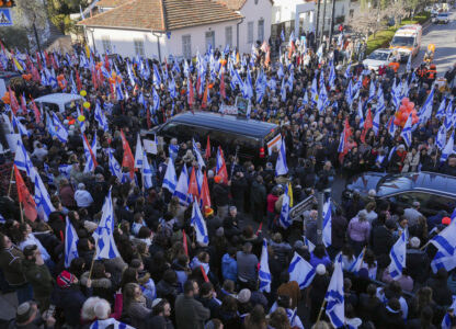 Mourners gather around the convoy carrying the coffins of slain hostages Shiri Bibas and her two children, Ariel and Kfir, during their funeral procession in Rishon Lezion, Israel, Wednesday, Feb. 26, 2025. The mother and her two children were abducted by Hamas on Oct. 7, 2023, and their remains were returned from Gaza to Israel last week as part of a ceasefire agreement with Hamas. (AP Photo/Ariel Schalit)