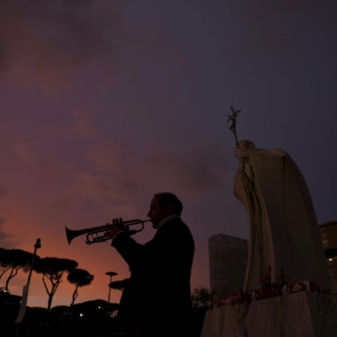Trumpeter Felice Carella is silhouetted as he plays the song Ave Maria for Pope Francis in front of the Agostino Gemelli Polyclinic, where the Pontiff has been hospitalized since Feb. 14, in Rome, Wednesday, Feb. 26, 2025. (AP Photo/Kirsty Wigglesworth)