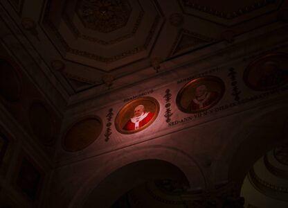 A light illuminates a polychrome mosaic portrait of Pope Francis placed on the frieze of St. Paul's Outside The Walls Basilica in Rome, Wednesday, Feb. 26, 2025. (AP Photo/Bernat Armangue)