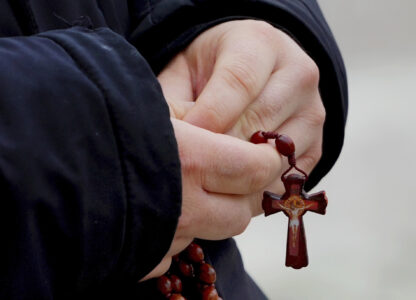 A man holds rosary beads as he prays for Pope Francis in front of the Agostino Gemelli Polyclinic, where the Pontiff has been hospitalized since Feb. 14, in Rome, Wednesday, Feb. 26, 2025. (AP Photo/Kirsty Wigglesworth)