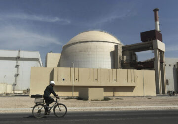 FILE - A worker rides a bicycle in front of the reactor building of the Bushehr nuclear power plant, just outside the southern city of Bushehr, Iran, Oct. 26, 2010. (Majid Asgaripour/Mehr News Agency via AP, File)