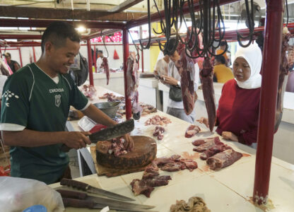 FILE - A butcher serves a customer at a market in Jakarta, Indonesia, Wednesday, March 22, 2023, during preparations to welcome the holy month of Ramadan, expected to start the following day. (AP Photo/ Ahmad Ibrahim, File)