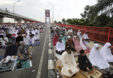FILE - Muslims perform an Eid al-Fitr prayer marking the end of the holy fasting month of Ramadan on Ampera Bridge in Palembang, South Sumatra, Indonesia, Saturday, April 22, 2023. (AP Photo/Binsar Bakkara, File)