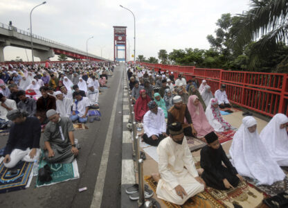 FILE - Muslims perform an Eid al-Fitr prayer marking the end of the holy fasting month of Ramadan on Ampera Bridge in Palembang, South Sumatra, Indonesia, Saturday, April 22, 2023. (AP Photo/Binsar Bakkara, File)