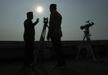 FILE - Officials are silhouetted as they use a telescope to scan the horizon for a crescent moon that will determine the beginning of the holy fasting month of Ramadan in Jakarta, Indonesia, Wednesday, March. 22, 2023. (AP Photo/Achmad Ibrahim, File)