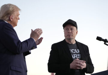FILE - Republican presidential nominee former President Donald Trump, left, claps as Tesla and SpaceX CEO Elon Musk prepares to depart after speaking at a campaign event at the Butler Farm Show, on Oct. 5, 2024, in Butler, Pa. (AP Photo/Alex Brandon, File)