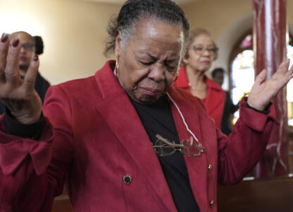 FILE - A congregant at Mother Bethel AME Church prays during a service in Philadelphia, Oct. 13, 2024. (AP Photo/Luis Andres Henao, File)