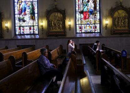 FILE - A parishioner prays at St. Peter the Apostle Catholic Church in Reading, Pa., June 16, 2024. (AP Photo/Luis Andres Henao, File)