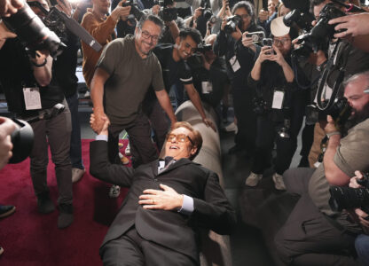 Conan O'Brien, host of Sunday's 97th Academy Awards, poses atop the red carpet during the annual red carpet roll out at the Dolby Theatre on Wednesday, Feb. 26, 2025, in Los Angeles. (AP Photo/Chris Pizzello)