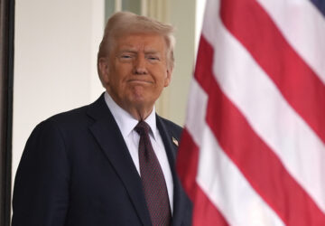 President Donald Trump stands before British Prime Minister Keir Starmer arrives at the White House, Thursday, Feb. 27, 2025, in Washington. (AP Photo/Evan Vucci)