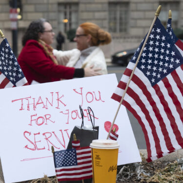 Flags and a sign thanking United States Agency for International Development (USAID) workers are pictured as USAID workers retrieve their personal belongings from USAID's headquarters in Washington, Thursday, Feb. 27, 2025, in Washington. (AP Photo/Manuel Balce Ceneta)