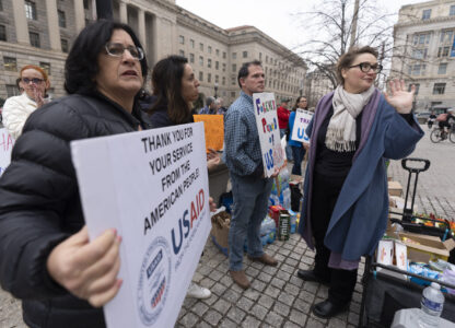 Former United States Agency for International Development (USAID) workers show their support to USAID workers retrieving their personal belongings from USAID's headquarters in Washington, Thursday, Feb. 27, 2025. (AP Photo/Manuel Balce Ceneta)