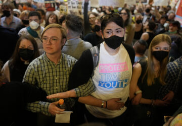 Protesters fill the Iowa state Capitol to denounce a bill that would strip the state civil rights code of protections based on gender identity, Thursday, Feb. 27, 2025, in Des Moines, Iowa. (AP Photo/Charlie Neibergall)