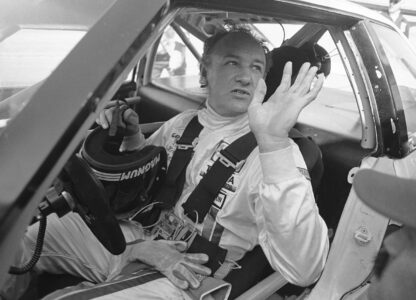 FILE - Actor Gene Hackman waves as he starts out for a practice run in his Toyota Celica, Feb. 5, 1983 at the Daytona International Speedway in preparation for the Daytona 24 Hour Endurac Race. This race marks the start of Hickman?s career as a professional driver. (AP Photo/Bob Self, File)