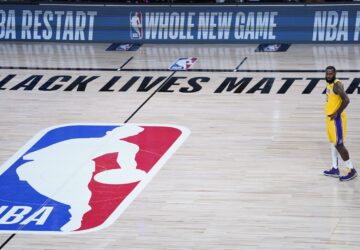 FILE - A Black Lives Matter sign is displayed on the court as Los Angeles Lakers' LeBron James prepares to face the Denver Nuggets in an NBA basketball game in Lake Buena Vista, Fla., on Aug. 10, 2020. (AP Photo/Ashley Landis, Pool, File)