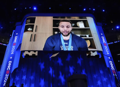 FILE - Displayed on a screen, Golden State Warriors guard Stephen Curry speaks during the Democratic National Convention in Chicago on Thursday, Aug. 22, 2024. (AP Photo/Brynn Anderson, File)