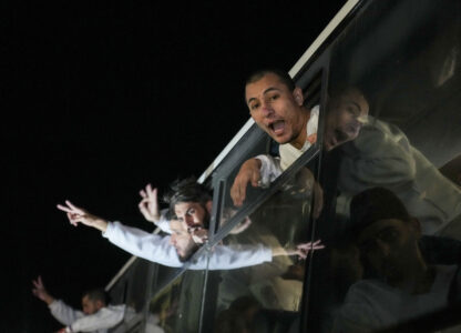Freed Palestinian prisoners wave from a bus as they arrive in the Gaza Strip after being released from an Israeli prison following a ceasefire agreement between Hamas and Israel in Khan Younis, Gaza Strip, Thursday, Feb. 27, 2025. (AP Photo/Abdel Kareem Hana)
