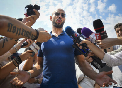 Andrew Tate speaks to media after being released from house arrest and put under judicial control measures, on the outskirts of Bucharest, Romania, Friday, Aug. 4, 2023. Andrew Tate, the divisive internet influencer who is charged in Romania with rape, human trafficking, and forming a criminal gang to sexually exploit women, won an appeal on Friday alongside his brother to be released from house arrest and will instead be put under judicial control measures, his spokesperson said. (AP Photo/Alexandru Dobre)