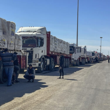 Trucks line up at the Egyptian side of the Rafah border crossing between Egypt and the Gaza Strip on Sunday, March 2, 2025. (AP Photo/Mohamed Arafat)