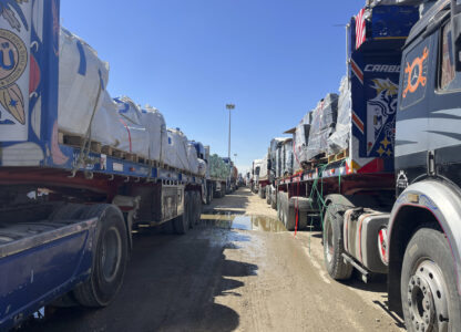 Trucks line up at the Egyptian side of the Rafah border crossing between Egypt and the Gaza Strip after Israel blocked the entry of aid trucks into Gaza, Sunday, March 2, 2025. (AP Photo/Mohamed Arafat)