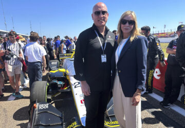 Dan Towriss, the new owner of Andretti Global, and Jill Gregory, president of Andretti Global, stand in front of Colton Herta's race car before the season-opening race, Sunday, March 2, 2025, in St. Petersburg, Fla. (AP Photo/Jenna Fryer)