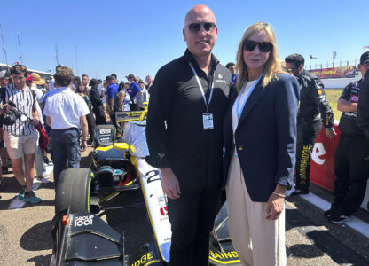 Dan Towriss, the new owner of Andretti Global, and Jill Gregory, president of Andretti Global, stand in front of Colton Herta's race car before the season-opening race, Sunday, March 2, 2025, in St. Petersburg, Fla. (AP Photo/Jenna Fryer)