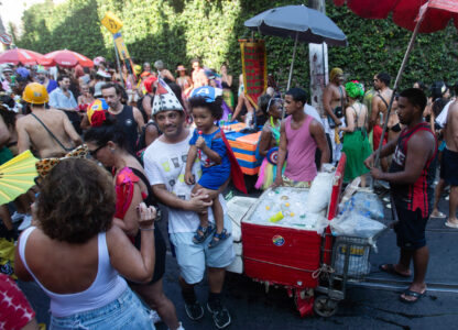 Revelers mill about as vendors with coolers filled with ice cold drinks wait for customers at the Heaven on Earth pre-Carnival street party, in Rio de Janeiro, Saturday, Feb. 22, 2025. (AP Photo/Bruna Prado)