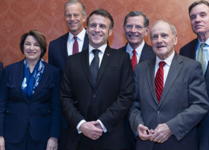 France's President Emmanuel Macron, center, is welcomed to the U.S. Capitol by, from left, Sen. Amy Klobuchar, D-Minn., Senate Majority Leader John Thune, R-S.D., Sen. John Barrasso, R-Wyo., Sen. James Risch, R-Idaho, and Sen. Mark Warner, D-Va., in Washington, Monday, Feb. 24, 2025. (AP Photo/J. Scott Applewhite)