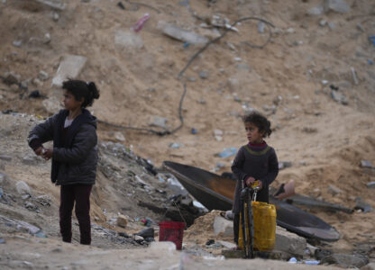 Displaced Palestinians girls fill a plastic jerrycan with water at a school run by UNRWA, the U.N. agency helping Palestinian refugees, which they use as a shelter west of Gaza City, Sunday, March 9, 2025. (AP Photo/Jehad Alshrafi)