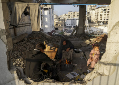 Displaced Palestinians make tea at a school run by UNRWA, the U.N. agency helping Palestinian refugees, west of Gaza City, Sunday, March 9, 2025. (AP Photo/Jehad Alshrafi)