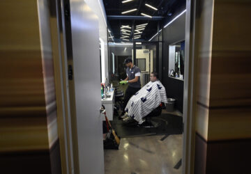A New York Yankees clubhouse attendant sits in a barber's chair during a tour of the upgraded team spring training facilities Thursday, Feb. 13, 2025, at George M. Steinbrenner Field in Tampa, Fla. (AP Photo/Steve Nesius)