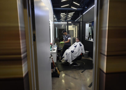 A New York Yankees clubhouse attendant sits in a barber's chair during a tour of the upgraded team spring training facilities Thursday, Feb. 13, 2025, at George M. Steinbrenner Field in Tampa, Fla. (AP Photo/Steve Nesius)