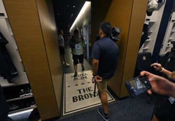 Members of the media walk through a hallway connecting the showers and the New York Yankees clubhouse during a tour of the upgraded team spring training facilities Thursday, Feb. 13, 2025, at George M. Steinbrenner Field in Tampa, Fla. (AP Photo/Steve Nesius)