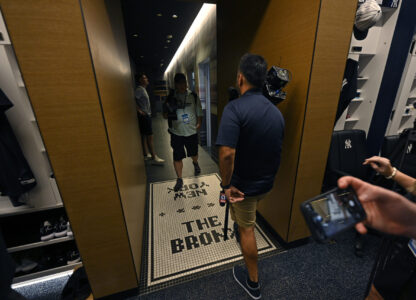Members of the media walk through a hallway connecting the showers and the New York Yankees clubhouse during a tour of the upgraded team spring training facilities Thursday, Feb. 13, 2025, at George M. Steinbrenner Field in Tampa, Fla. (AP Photo/Steve Nesius)