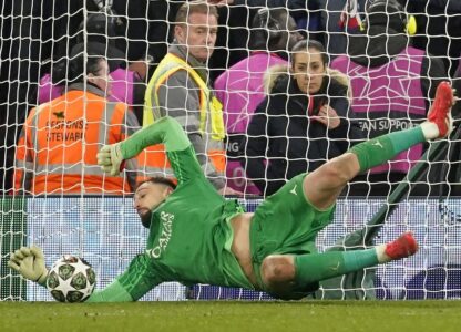 PSG's goalkeeper Gianluigi Donnarumma saves a penalty from Liverpool's Curtis Jones during a shootout at the end of the Champions League round of 16 second leg soccer match between Liverpool and Paris Saint-Germain at Anfield in Liverpool, England, Tuesday, March 11, 2025. (AP Photo/Dave Thompson)