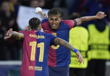 Barcelona's Raphinha, left, celebrates with his teammate Lamine Yamal after scoring his side's opening goal during the Champions League round of 16 second leg soccer match between FC Barcelona and SL Benfica at the Lluis Companys Olympic Stadium in Barcelona, Spain, Tuesday, March 11, 2025. (AP Photo/Emilio Morenatti)