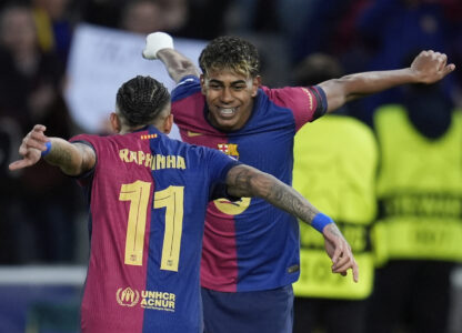 Barcelona's Raphinha, left, celebrates with his teammate Lamine Yamal after scoring his side's opening goal during the Champions League round of 16 second leg soccer match between FC Barcelona and SL Benfica at the Lluis Companys Olympic Stadium in Barcelona, Spain, Tuesday, March 11, 2025. (AP Photo/Emilio Morenatti)