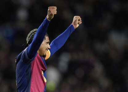 Barcelona's Ronald Araujo celebrates at the end of the Champions League round of 16 second leg soccer match between FC Barcelona and SL Benfica at the Lluis Companys Olympic Stadium in Barcelona, Spain, Tuesday, March 11, 2025. (AP Photo/Emilio Morenatti)