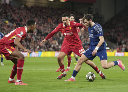 Liverpool's Trent Alexander-Arnold guards PSG's Khvicha Kvaratskhelia during the Champions League round of 16 second leg soccer match between Liverpool and Paris Saint-Germain at Anfield in Liverpool, England, Tuesday, March 11, 2025. (AP Photo/Jon Super)
