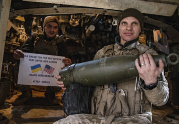 Soldiers of Ukraine's 5th brigade hold a poster thanking for the US for support during a flashmob at the front line near Toretsk, Donetsk region, Ukraine, Tuesday, March 11, 2025. (AP Photo/Roman Chop)