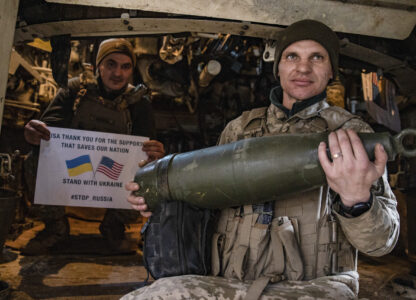 Soldiers of Ukraine's 5th brigade hold a poster thanking for the US for support during a flashmob at the front line near Toretsk, Donetsk region, Ukraine, Tuesday, March 11, 2025. (AP Photo/Roman Chop)