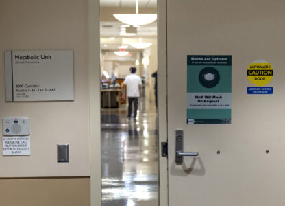 A worker walks down a corridor of a hospital unit where college student and research subject Sam Srisatta lives as part of a study on the health effects of ultraprocessed foods at the National Institutes of Health in Bethesda, Md., on Thursday, Oct. 31, 2024. (AP Photo/Mark Schiefelbein)