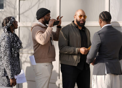 Retired NFL player T.J. Wright, left, and current NFL player Charles Harris, second from left, direct retired NFL player Copeland Bryan, second from right, and current NFL player Daiyan Henley as they film a scene from the film 