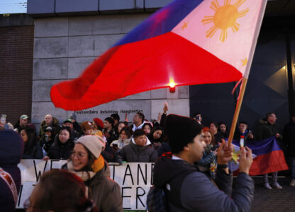 Supporters of former Philippine President Rodrigo Duterte hold flags and banners during a demonstration outside the International Criminal Court detention center near The Hague in Scheveningen, Netherlands, Wednesday, March 12, 2025. (AP Photo/Omar Havana)