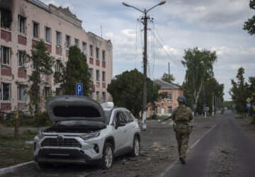 FILE - A Ukrainian soldier walks past at a city hall in Sudzha, Kursk region, Russia, Friday, Aug. 16, 2024. This image was approved by the Ukrainian Defense Ministry before publication. (AP Photo, File)